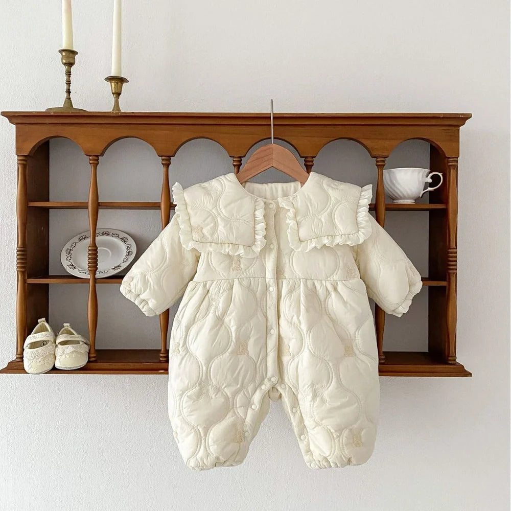 Newborn in light beige fleece-lined quilted cotton jumpsuit with single-breasted closure