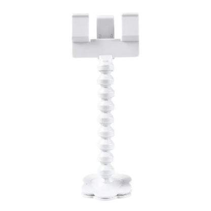 Black plastic pet photography tool attached to mobile phone with treat clip extended