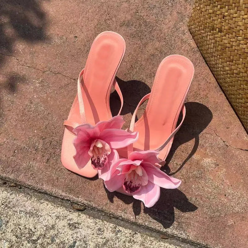 Pink women's flip-flop sandals with artificial Phalaenopsis orchid flower and square-toe design