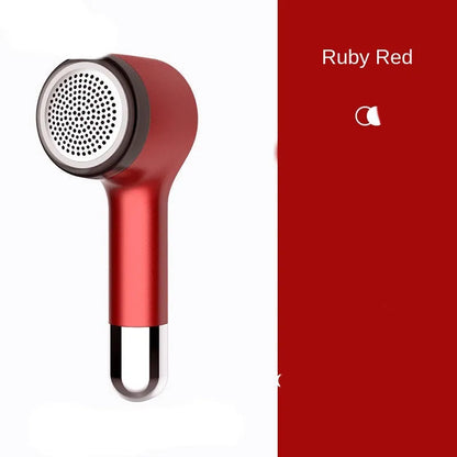 USB rechargeable hair ball trimmer in black, green, red, or white on a fabric background.