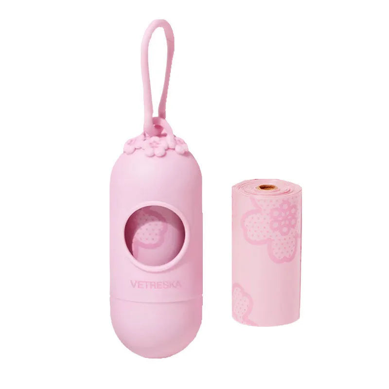 Plastic dog poop bag dispenser capsule clipped to a lead next to a roll of scented waste bags.