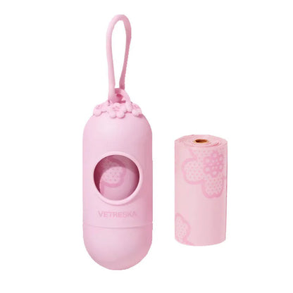 Plastic dog poop bag dispenser capsule clipped to a lead next to a roll of scented waste bags.