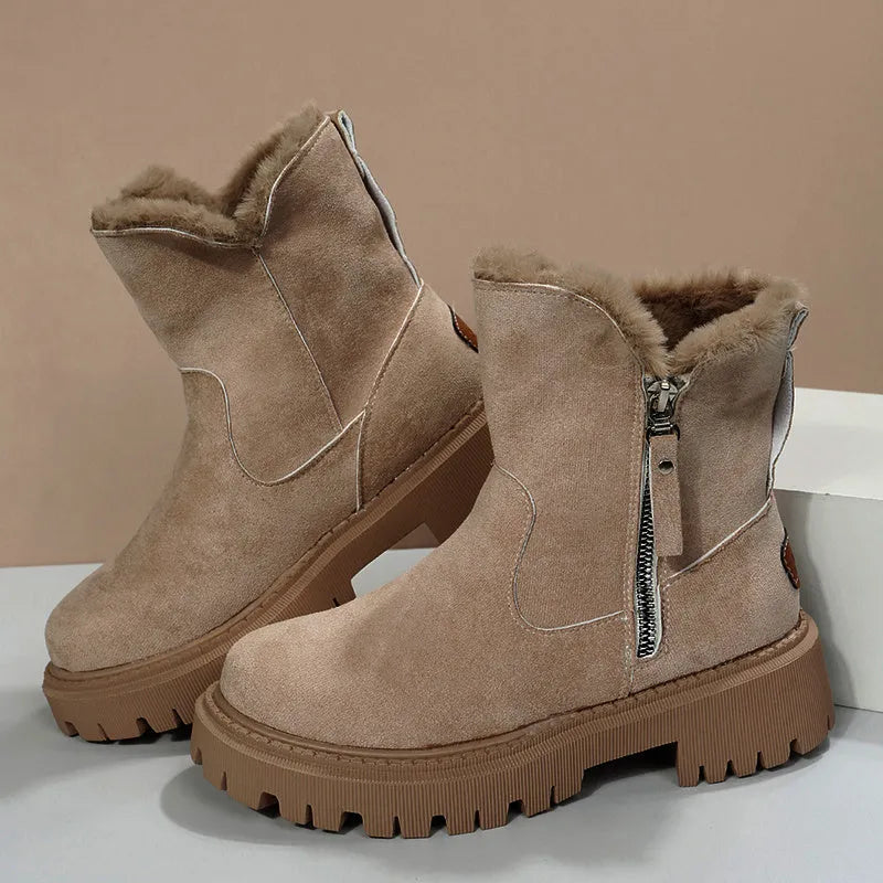 Women's black high top snow boots with a faux suede upper and side zipper on a white background.