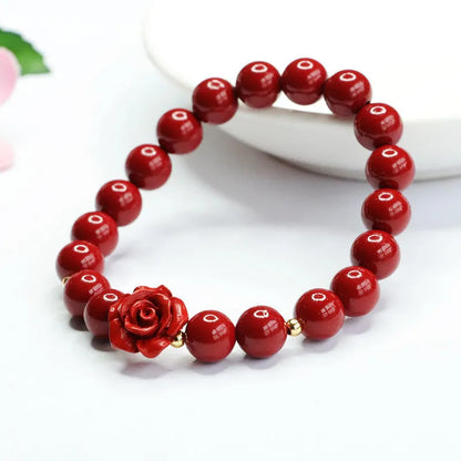 Close-up of a handmade purple gold sand cinnabar rose bracelet with an 8mm bead.