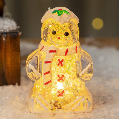 Glowing gingerbread man Christmas ornament measuring 6.5cm wide with LED lights and red scarf
