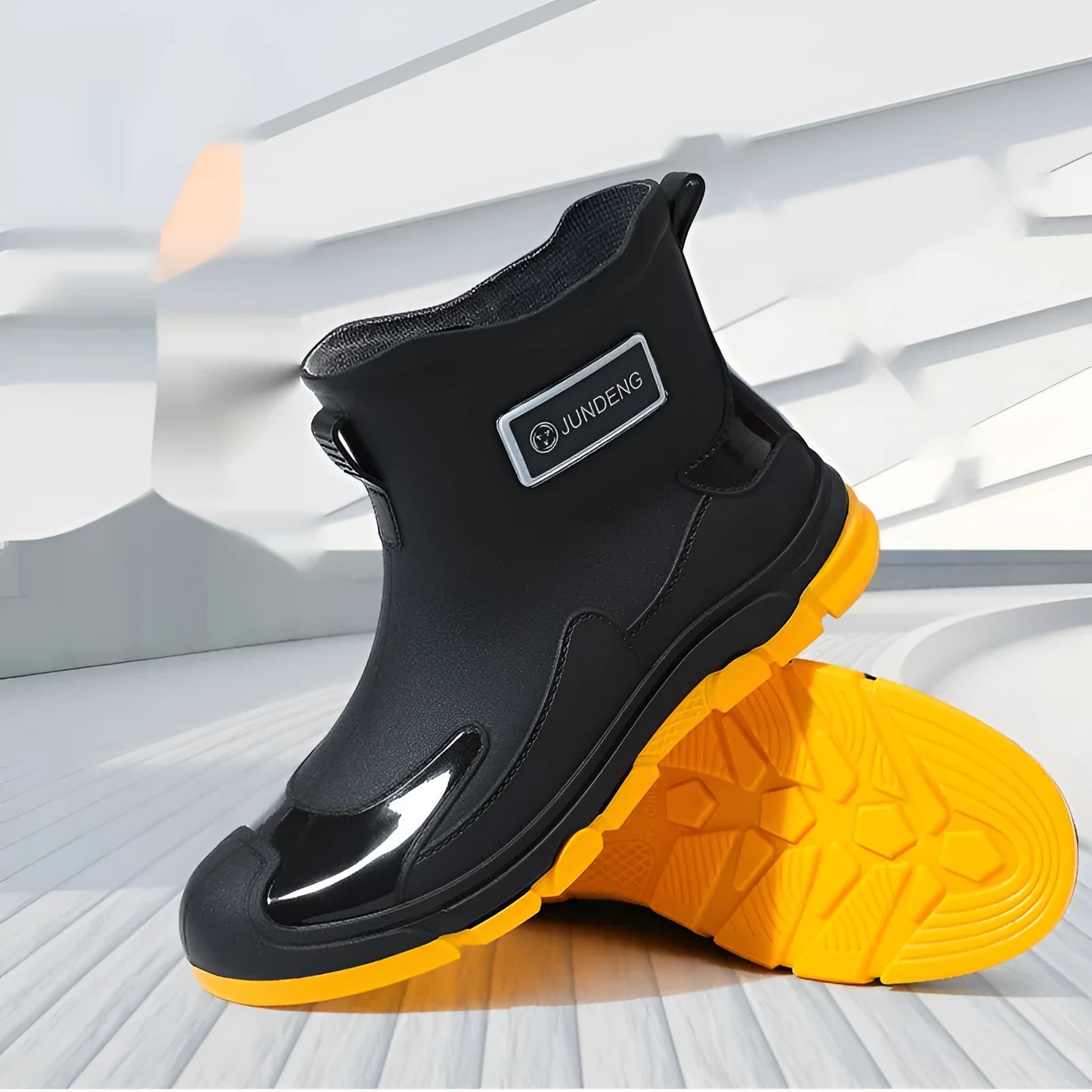 Women's short tube PVC waterproof boots in black with a round toe and flat plastic sole.