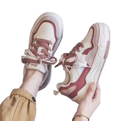 Women's beige and pink low-top sneakers with a rubber sole featuring hidden height increase.
