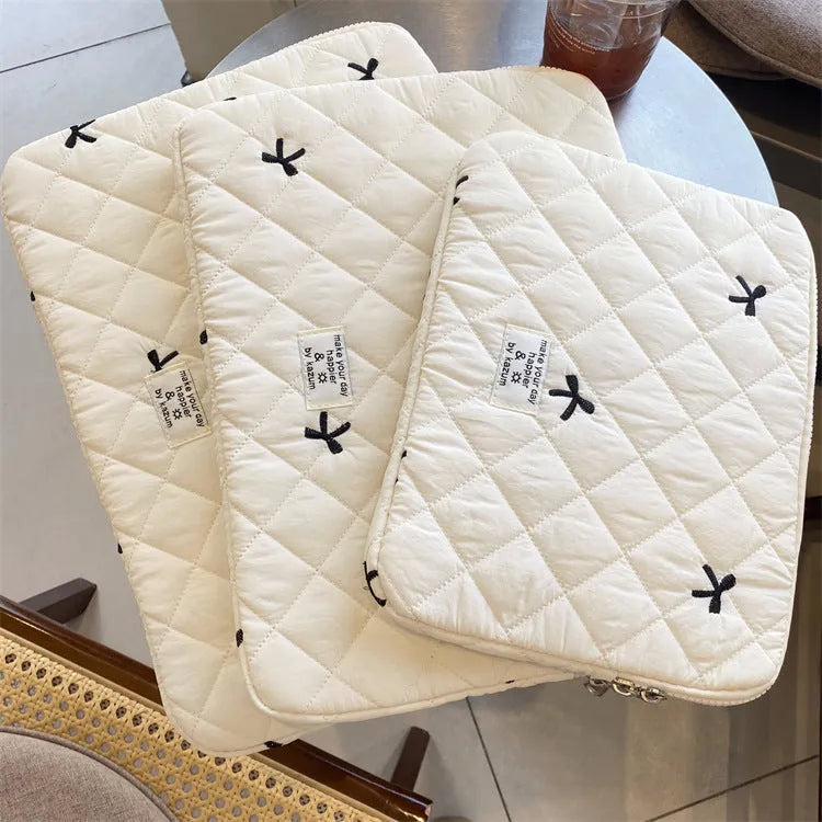 Nylon notebook storage bag with rhombus embroidery and bow, shown in light blue colour.