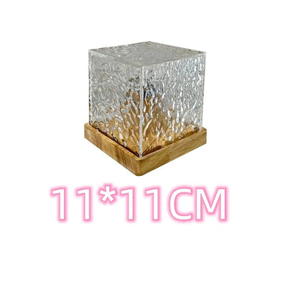 LED water ripple projection night light with remote control on wooden base showing colourful light patterns