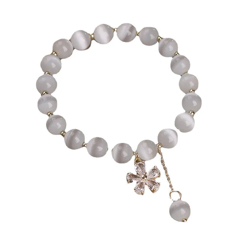 Single loop women's small flower tassel white cat's eye crystal bracelet featuring an adjustable safety buckle clasp pendant with one-piece packing in an original design style