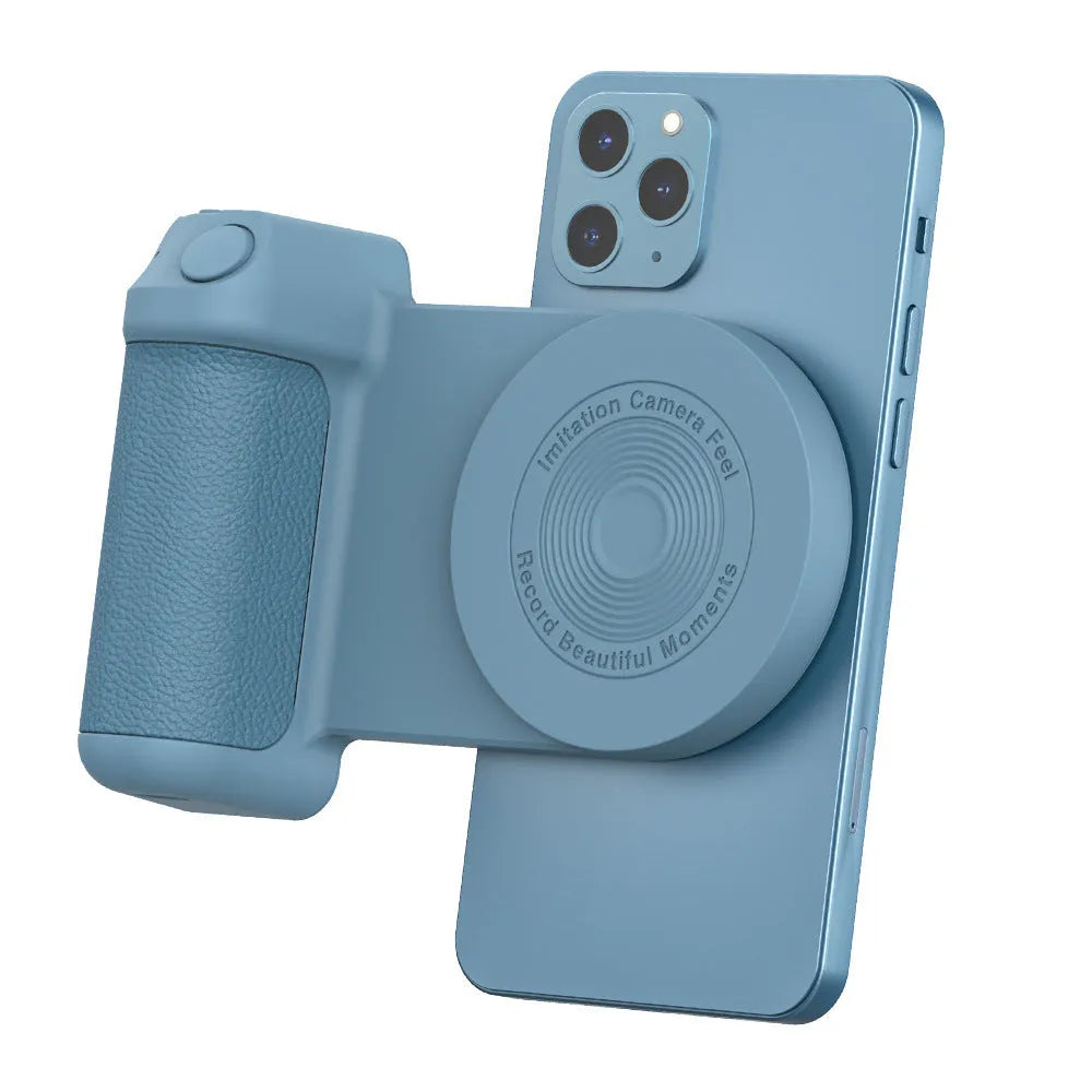 Black magnetic phone camera grip holder with rotatable stand on a table next to a smartphone.