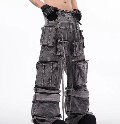 Grey distressed denim overalls with rope stitching on a man, showcasing the mop pant style.