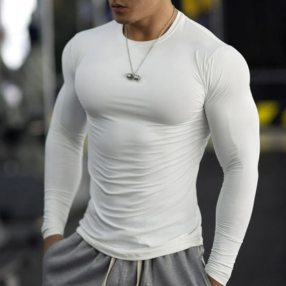 Man wearing black long sleeve slim fit fitness tights for running or gym workout.