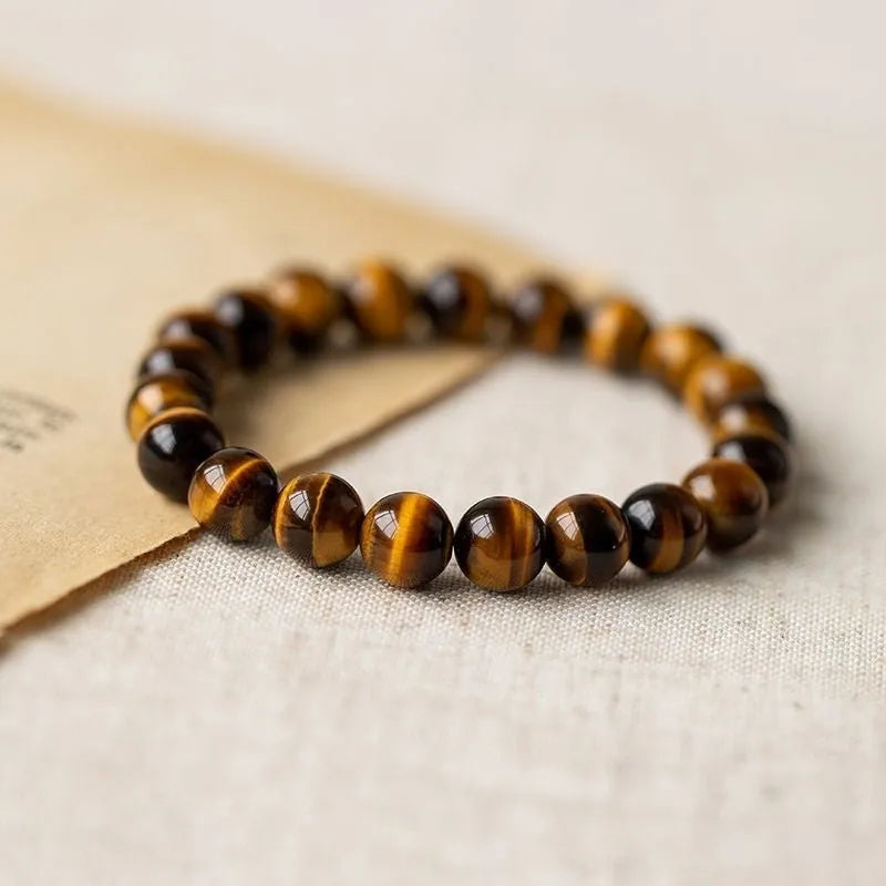 Single-circle beaded Buddha bracelet with tigereye Dzi stone, showing bead size options.