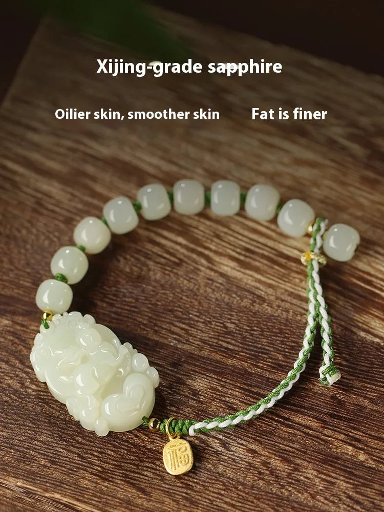 Hetian jade bracelet with a rabbit zodiac charm and S925 silver card on a red ice cotton rope.