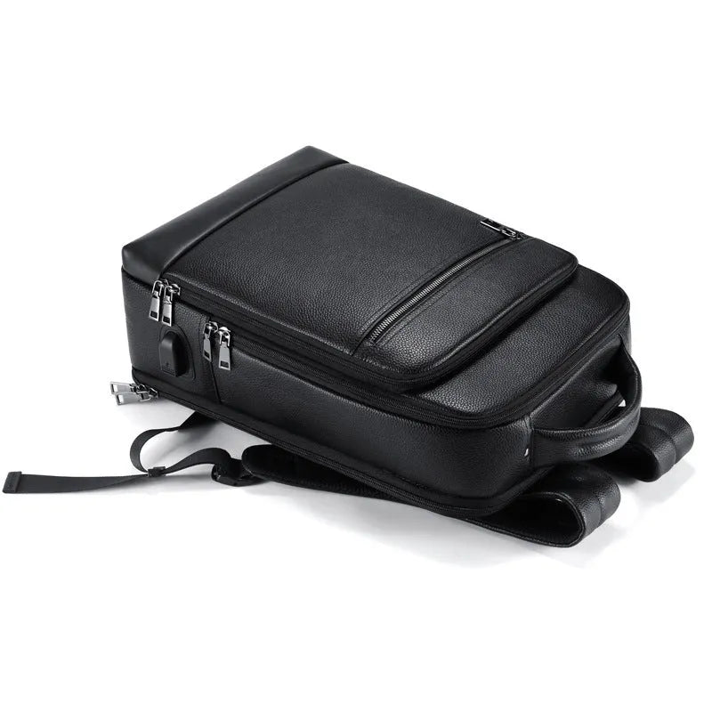 Leather men's business computer backpack, genuine first-layer cowhide construction, curved shoulder strap bearing system, below 20L capacity, solid black colour, designed for business travel and daily commuting.