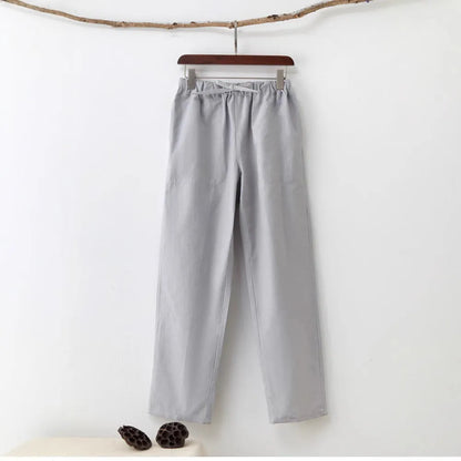 Men's beige pure cotton casual trousers with a drawstring waist on a mid-grey background.