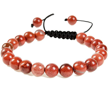 Close-up of a women's flat knot braided healing bracelet hand-woven with colourful gemstones.