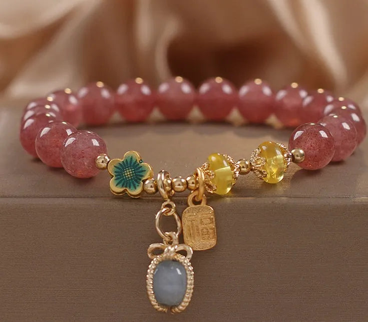 Red women's bracelet with strawberry quartz beads and rhinestones on an alloy chain.