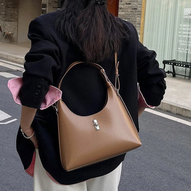 Genuine leather dumpling-shaped crossbody shoulder bag in six colour options showing sandwich pocket and internal organisation