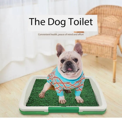 Green synthetic grass indoor dog toilet tray with plastic base for puppy training.