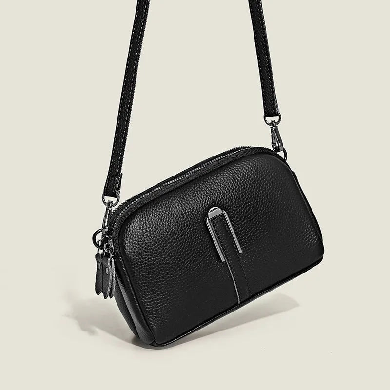 Minimalist top-grain leather crossbody bag in horizontal square shape with inner pockets, available in five colours