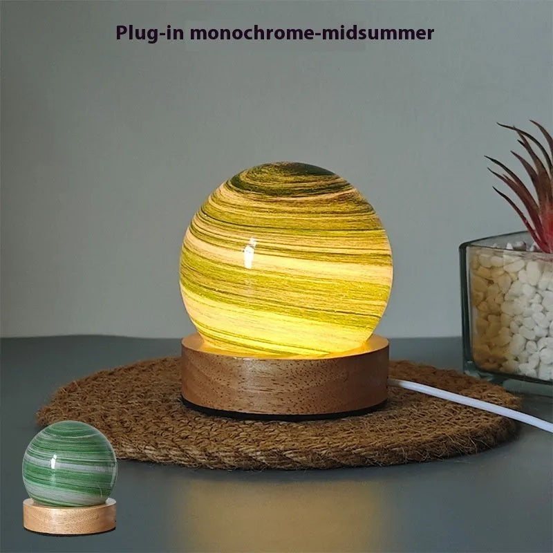 Planet-shaped USB night light with adjustable dimming in 12 colour options on its base.