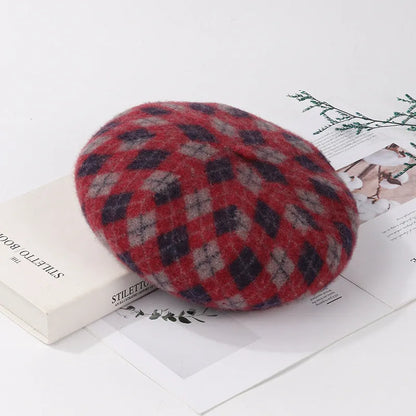 Wool plaid beret with dome crown, adjustable size, and tassel and mesh detail in blue light coffee plaid.