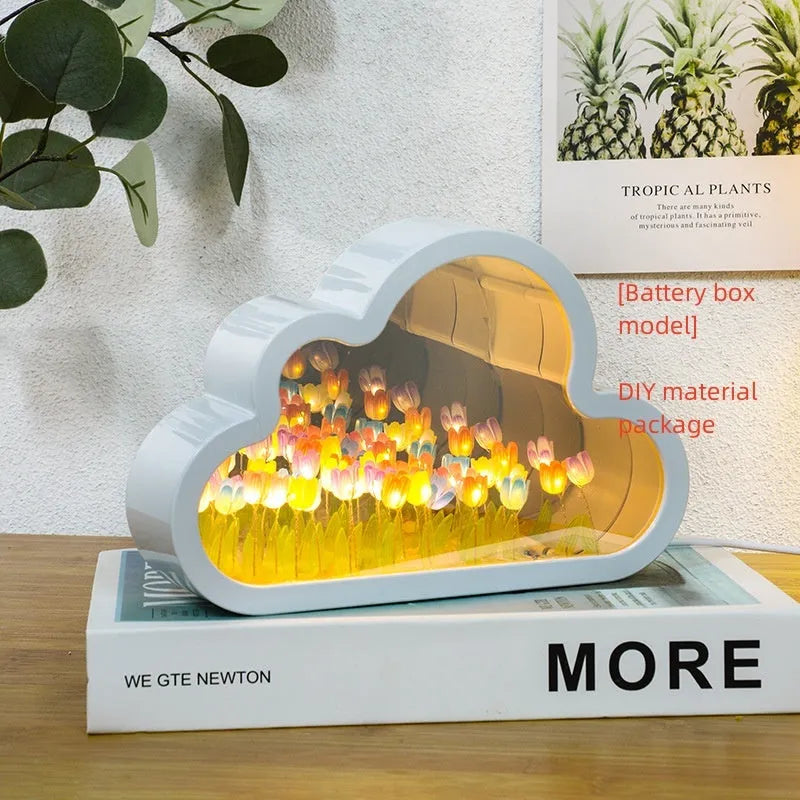 DIY tulip-shaped night lamp kit with LED lights and mirror surface in assorted colours on a desk.