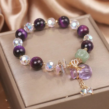 Women's forest style crystal bracelet with purple tigereye money bag pendant and rhinestone details