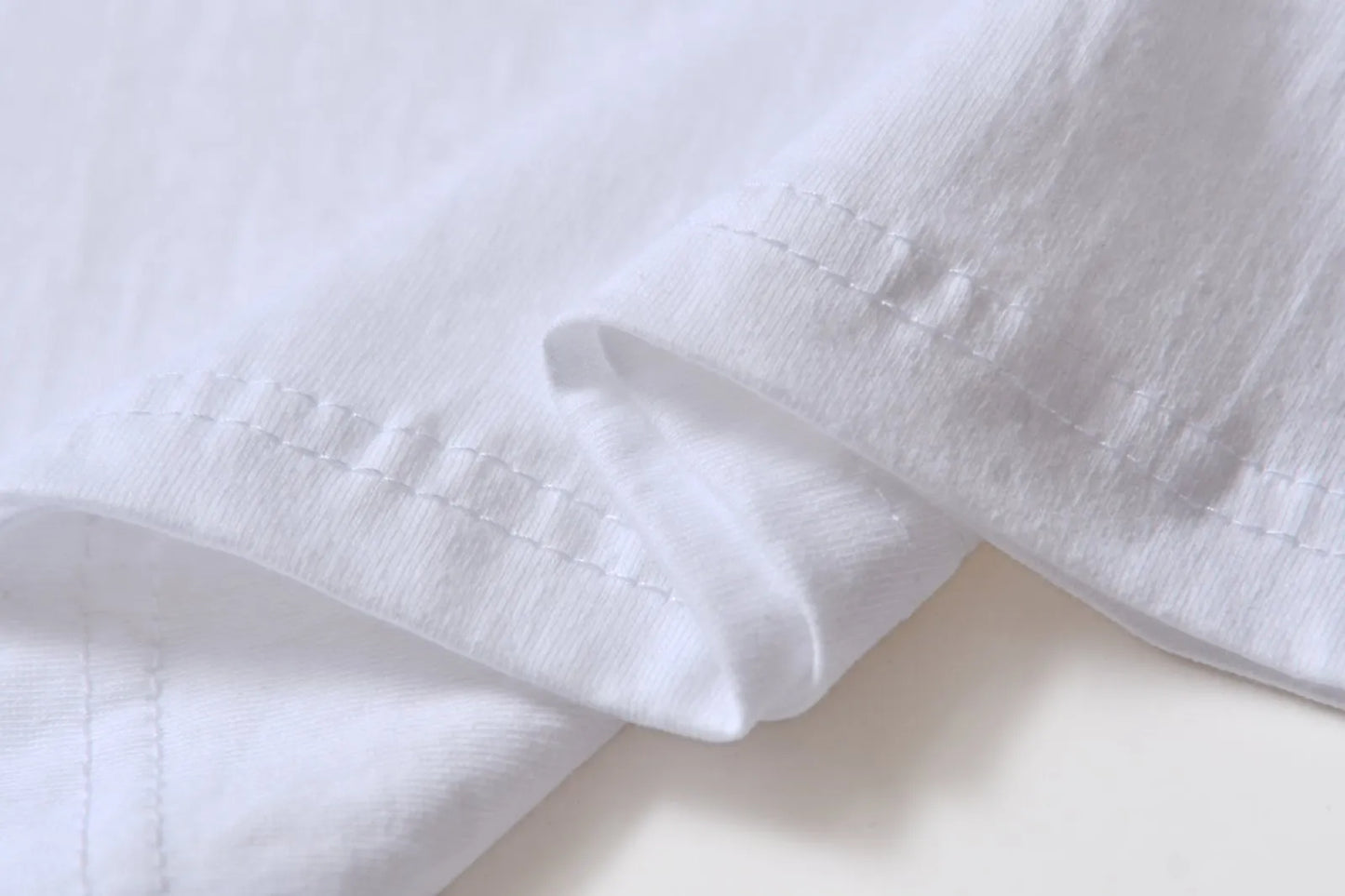 White cotton pullover overalls with a pattern, short sleeves, and a round neck on a teenager.
