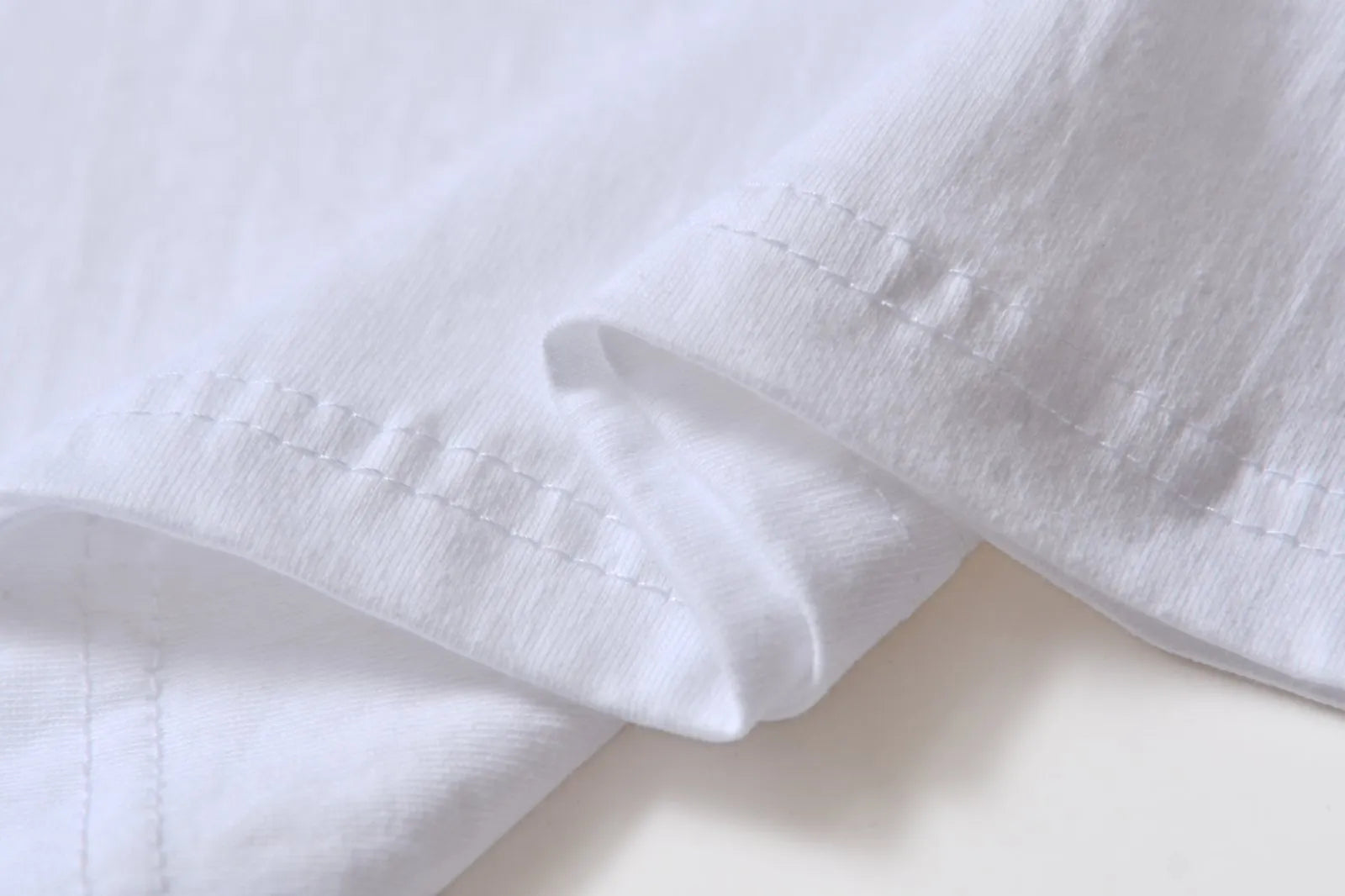White cotton pullover overalls with a pattern, short sleeves, and a round neck on a teenager.