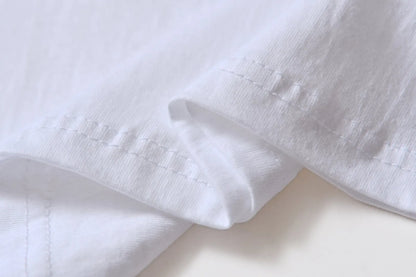White cotton pullover overalls with a pattern, short sleeves, and a round neck on a teenager.