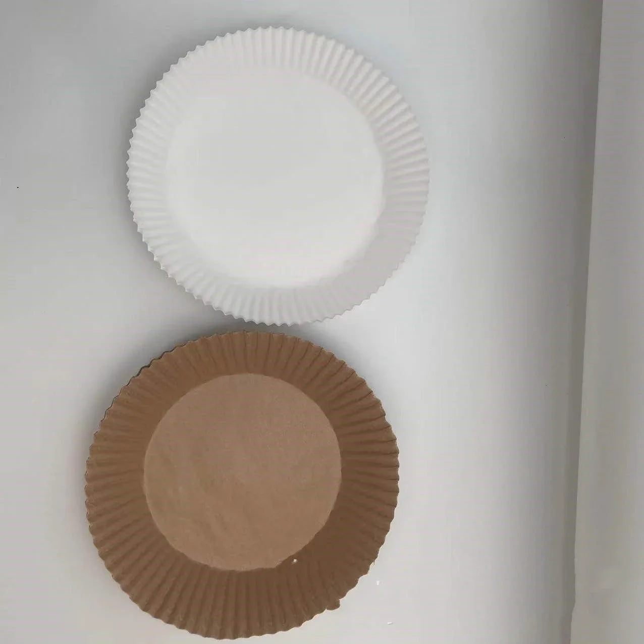 Disposable air fryer liners made of durable, food-grade parchment paper for effortless cleanup and healthy cooking