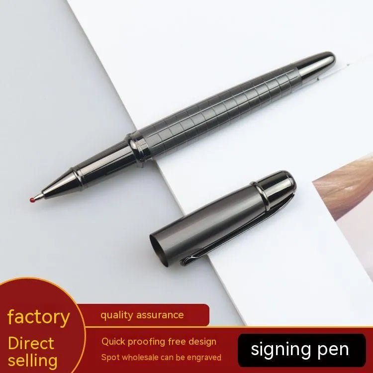 Gun grey metal rollerball pen with a metal barrel on a flat surface.