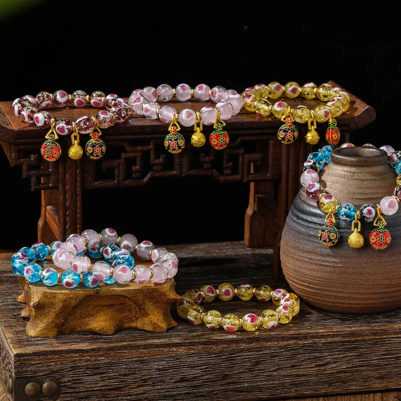Handmade glass bracelet with 10mm swallowing gold beast cherry blossom heart charm in six colour options