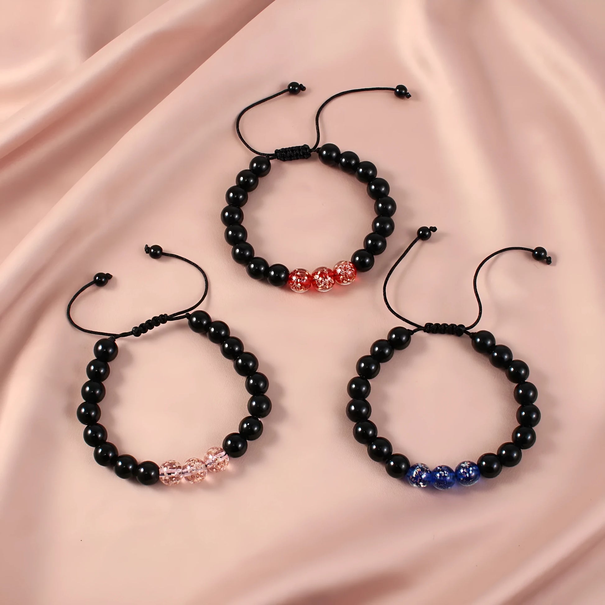 Adjustable bracelet with luminous geometric glass beads in six colour options on a wrist