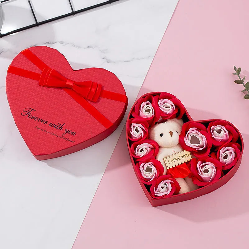 Red heart-shaped gift box open to reveal soap roses inside.