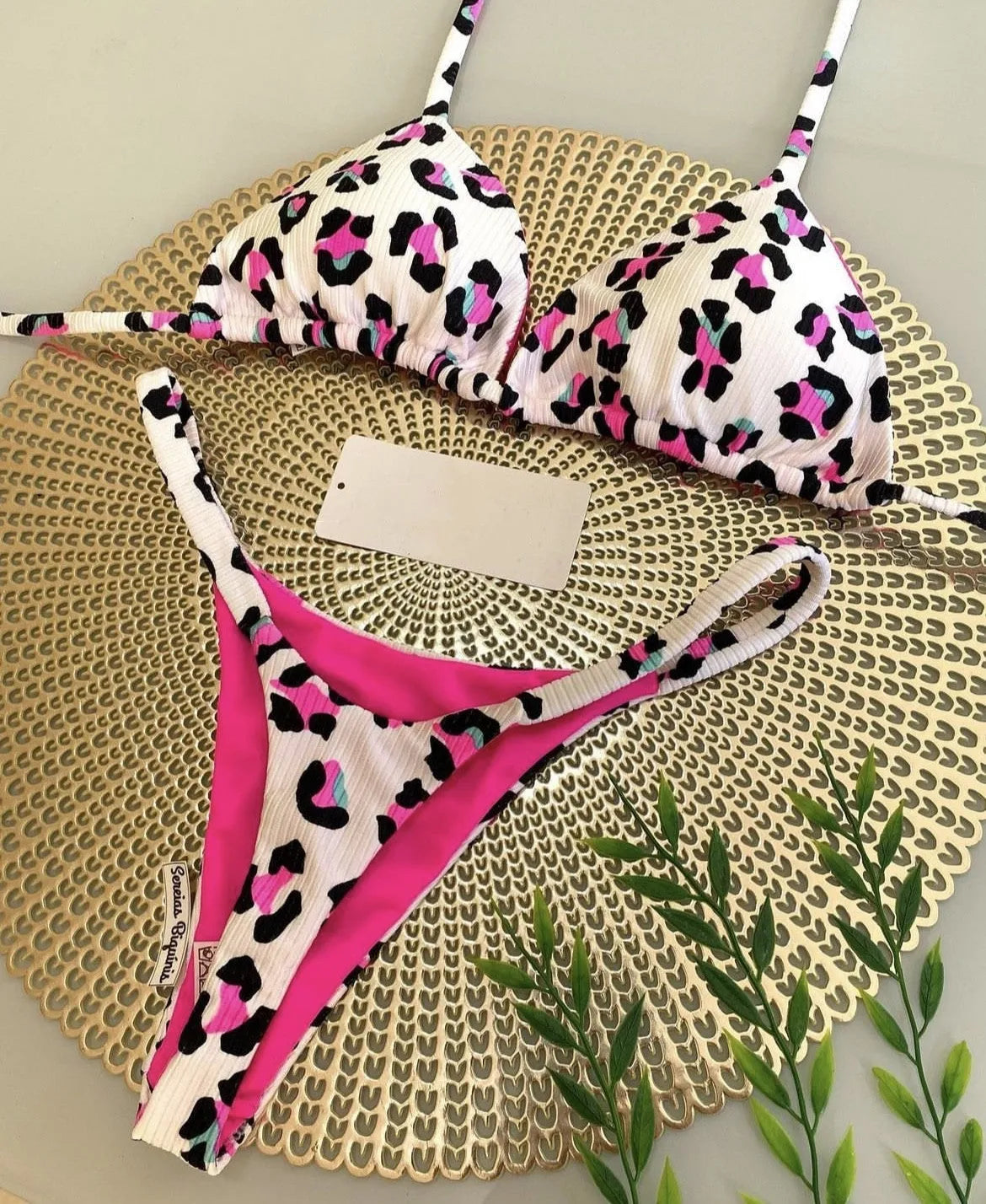 Women's printed bikini swimsuit with briefs style and cotton lining on a mannequin.