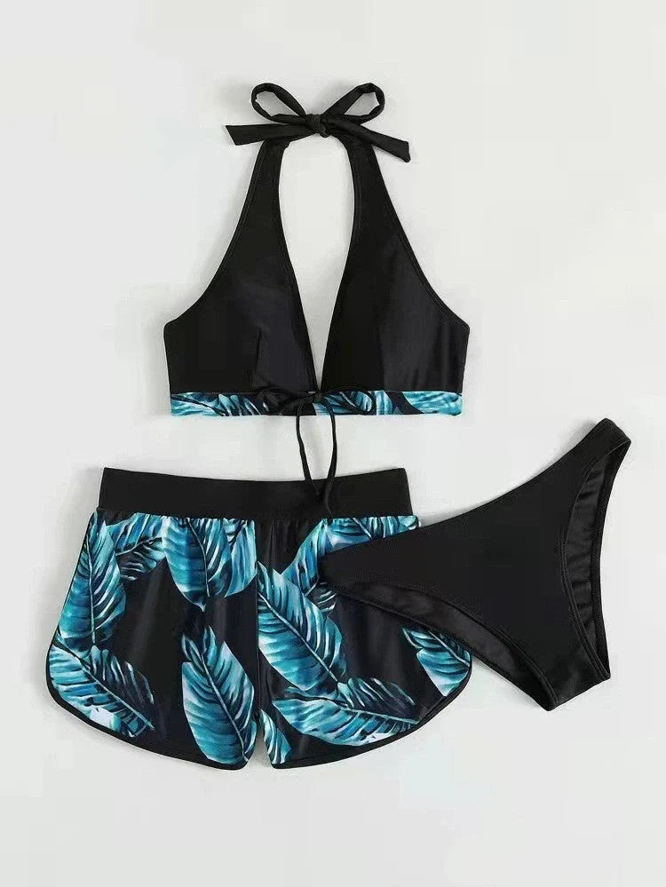 A stylish 3-piece swimsuit set featuring a unique leaf print design, including a top, bottoms, and matching shorts.