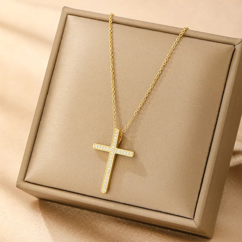 Women's gold electroplated copper necklace showing four pendant options: heart, butterfly, cross and round diamond