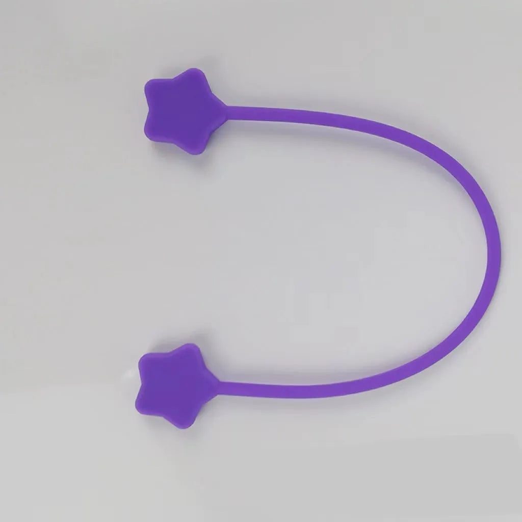 Compact purple silicone cable winder with magnet, shown coiling a white headphone cable.