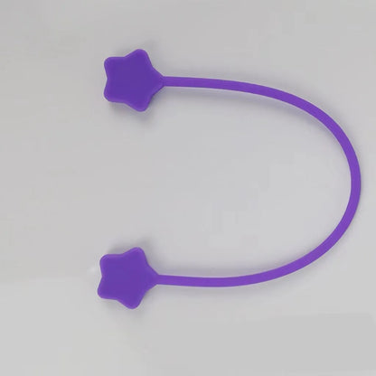 Compact purple silicone cable winder with magnet, shown coiling a white headphone cable.