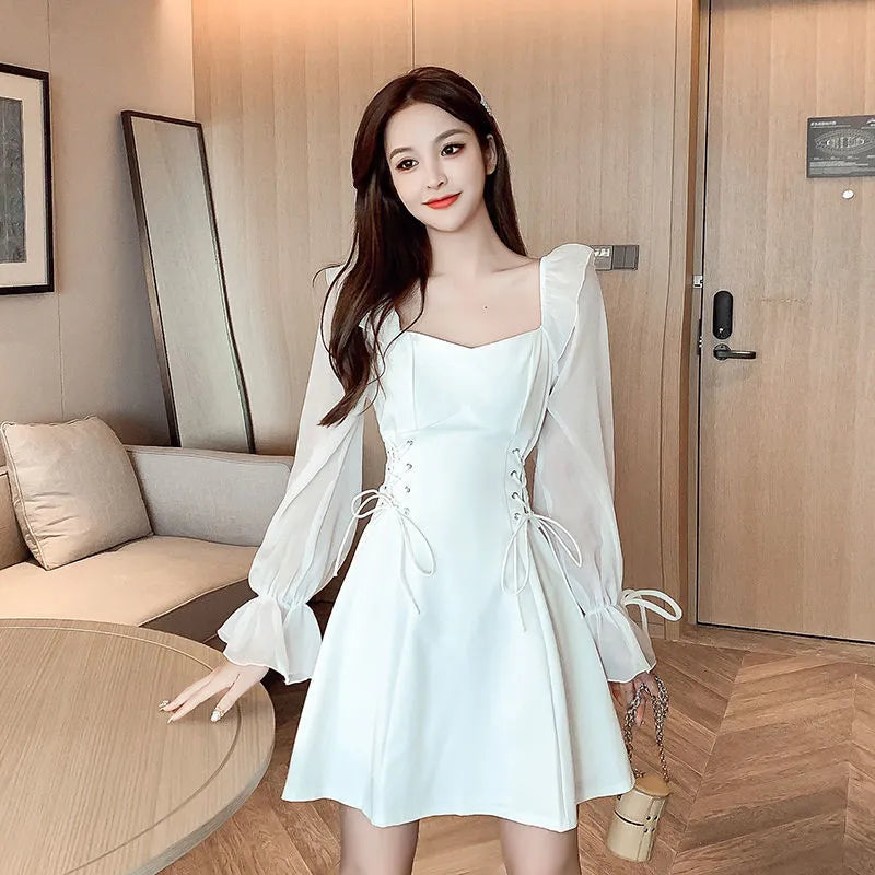 White chiffon patchwork dress with long sleeves and a waist-slimming design on a mannequin.