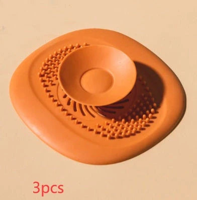 TPR vortex design sink drain cover in twilight orange, quiet blue, mango yellow, and gentian green