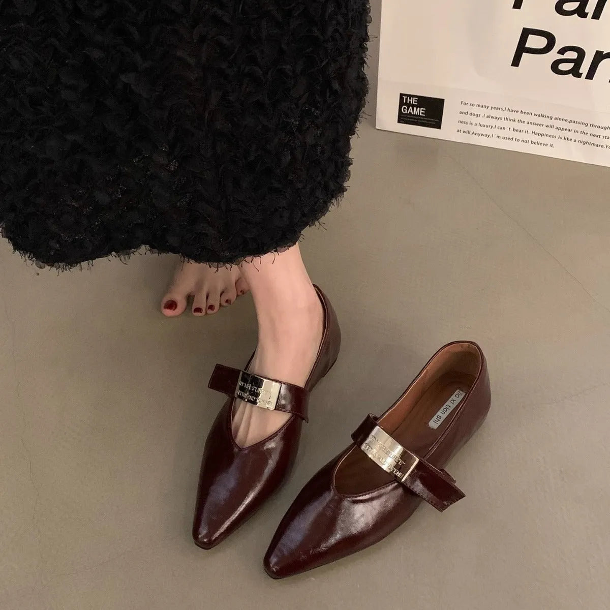 Women's black pointed toe Mary Jane shoes with silver buckle and low block heel