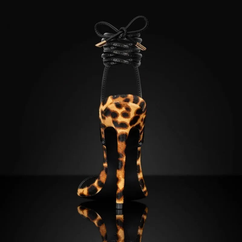 Women's leopard print pointed toe Roman sandals with a lace-up front and buckle.