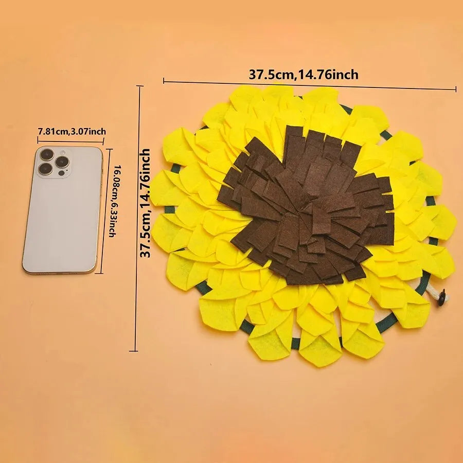 Yellow sunflower-shaped dog snuffle mat for slow feeding and nosework training on a floor.