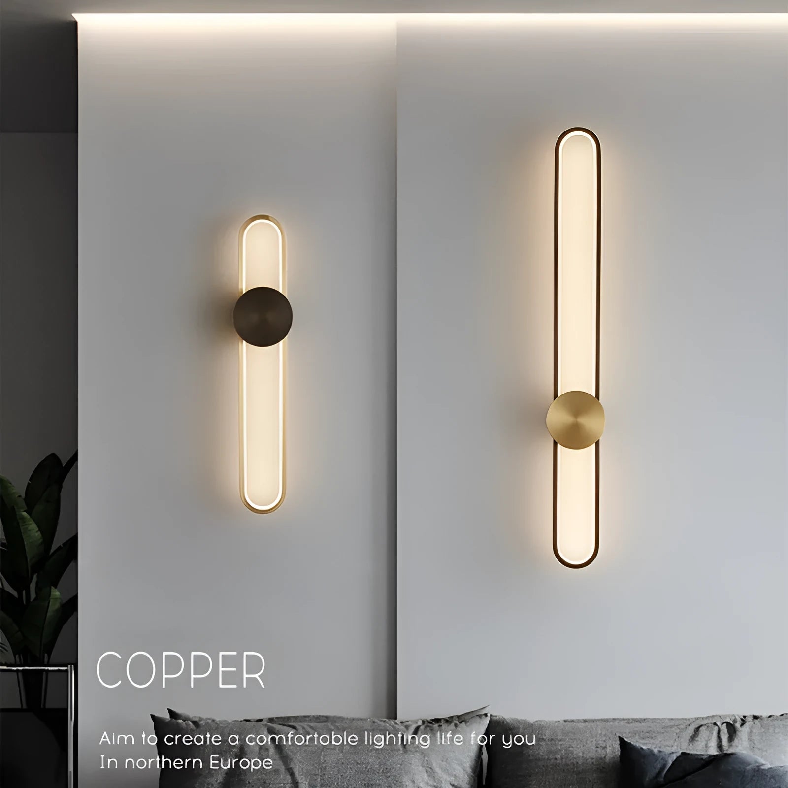 Round black iron wall sconce with integrated LED light glowing on a modern grey wall