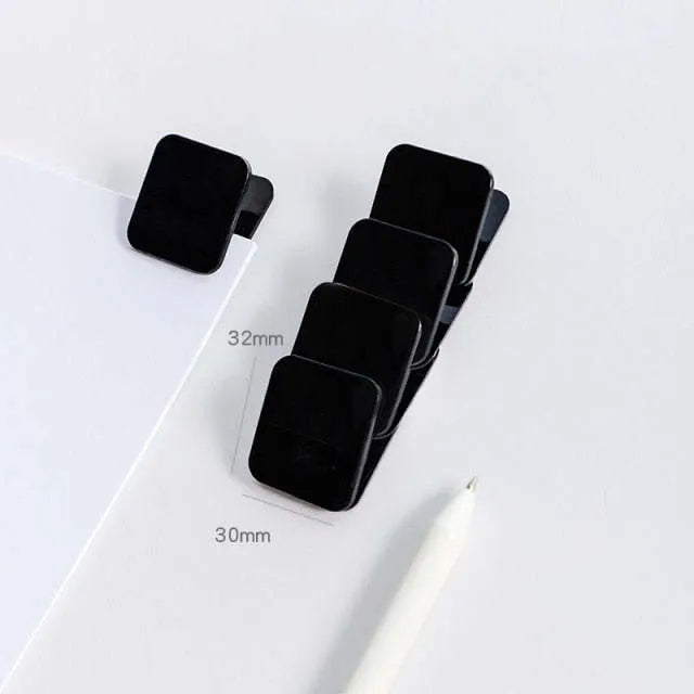 Square plastic photo holder in black, white, and transparent colour options on desk